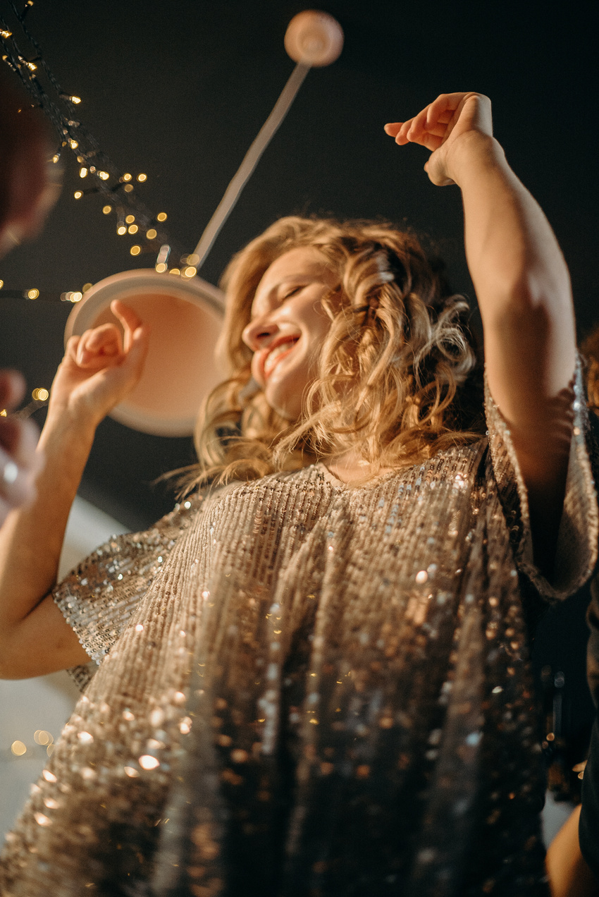 Selective Focus Photography of Smiling Woman Wearing Gray Dress Dancing